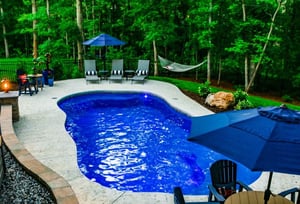 C Series pool with textured concrete patio and in-pool light